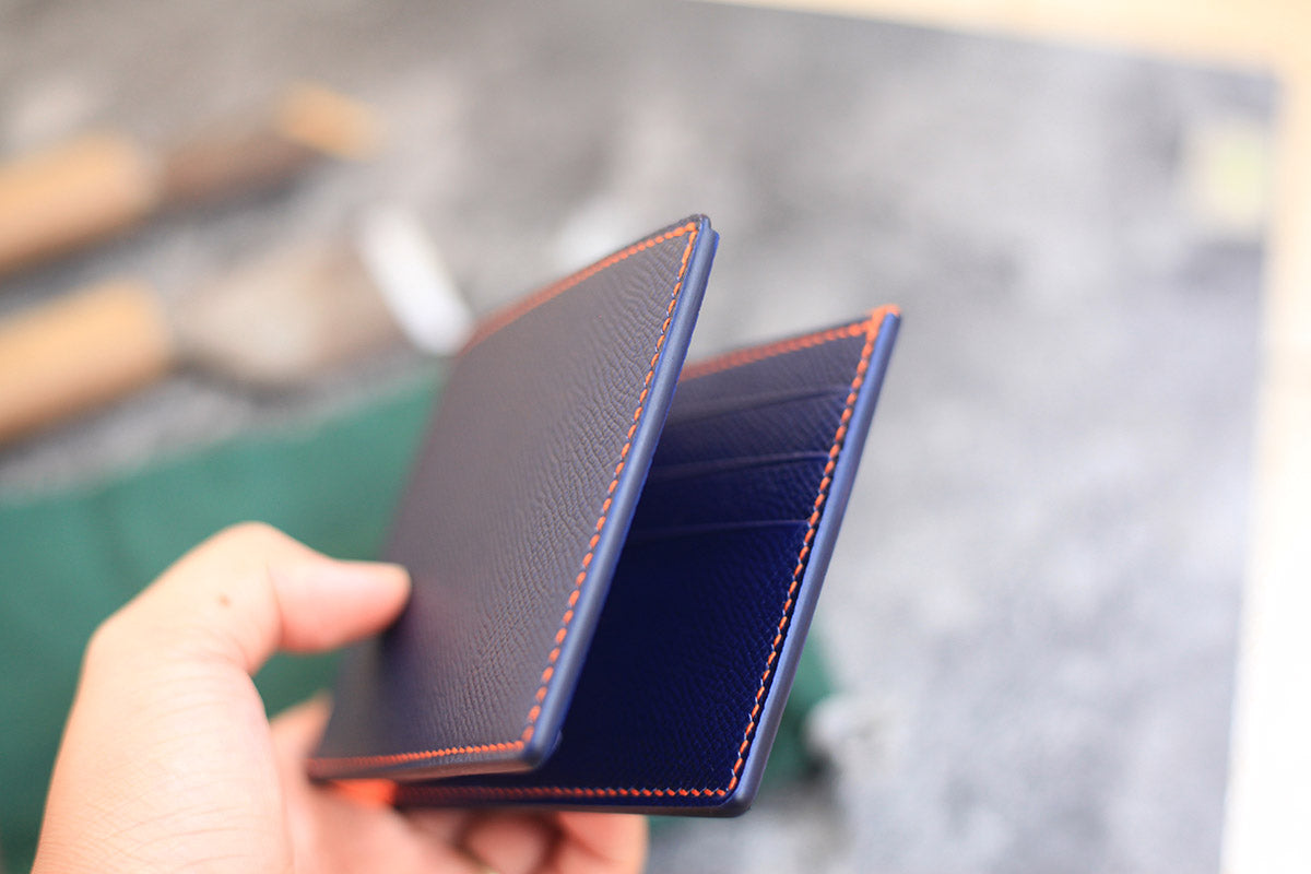 light dark blue orange leather bifold wallet